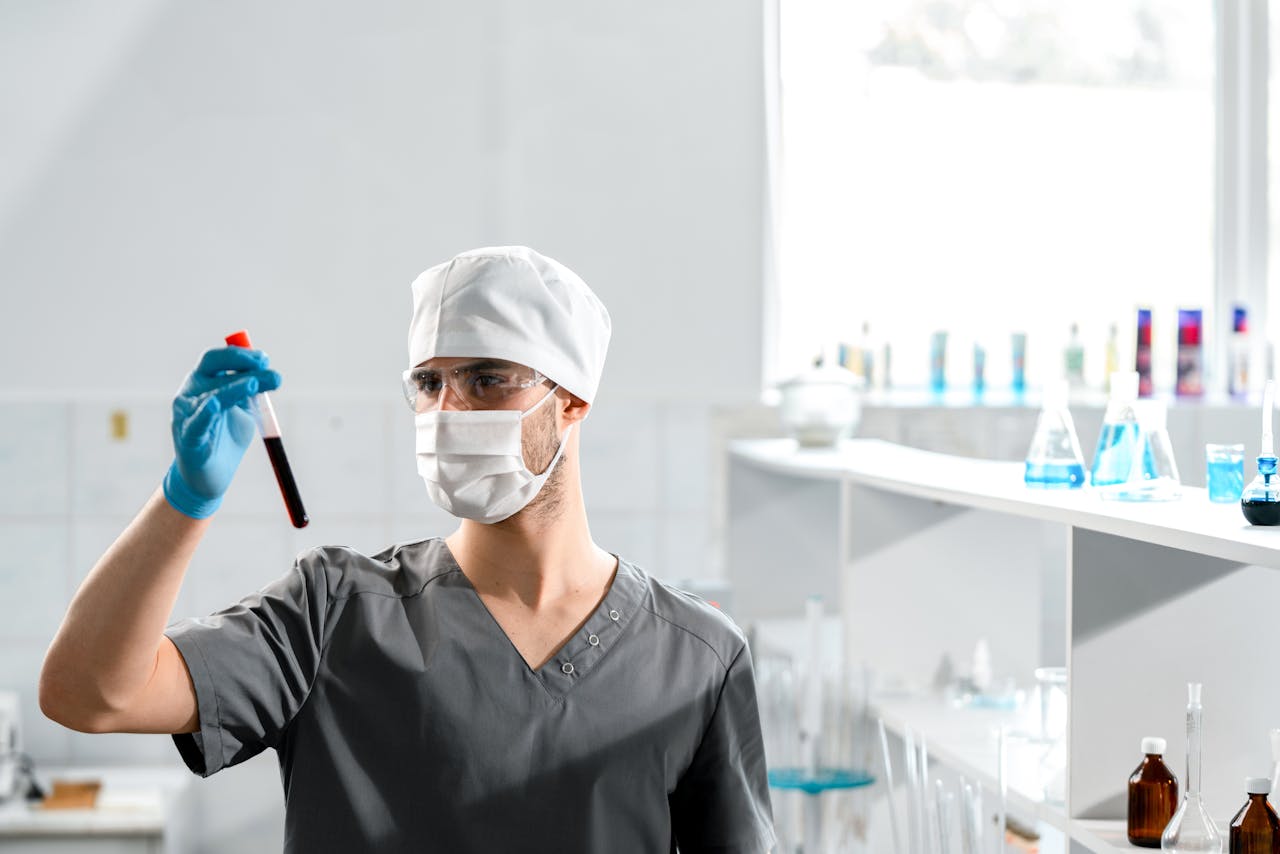 who-we-are A medical professional analyzing a blood sample in a bright laboratory setting.